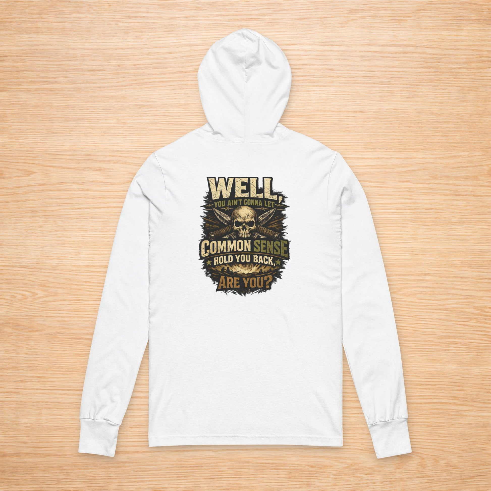White hoodie with a graphic design on a wooden surface