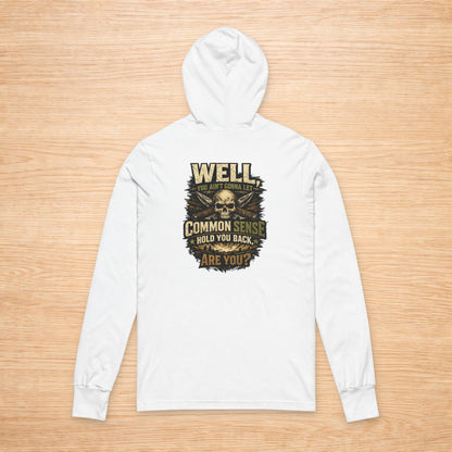 White hoodie with a graphic design on a wooden surface